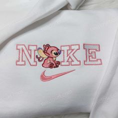 Angel Stitch Nike Embroidered Sweatshirt, Lilo & Stitch Embroidered Hoodie, Custom Nike Logo Shirt Our clothing store offers a unique selection of embroidered sweatshirts, t-shirts, and hoodies that are perfect for any occasion. Our Angel Stitch Nike embroidered sweatshirt is a standout piece that combines the iconic Nike brand with a playful touch of the beloved Disney character, Angel. The embroidery is skillfully crafted and adds dimension and texture to the sweatshirt, making it a statem White Hooded Top With Machine Embroidery, Cute White Embroidered Hoodie, White Embroidered Hooded Hoodie, Luffy Nike, Lilo And Stitch Hoodie, Stitch Nike, Nike Embroidered Sweatshirt, Angel Stitch, Stitch Sweatshirt