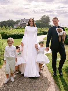 a man in a tuxedo with two children and an adult