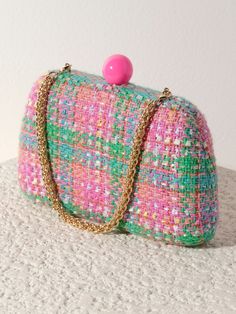 Meet your favorite fall clutch, the Lana Minaudiere from Shiraleah. This versatile bag features a trendy tweed texture in a chic pink and green color pattern with a pink push lock closure. With its interchangeable single handle and cross-body chain, this little purse can be worn as a clutch, a mini bag, or a cross-body! The Lana Minaudiere effortlessly exudes style and sophistication. Pair with other items from the Shiraleah collection to complete your look! Shiraleah is a trend-driven lifestyle Chic Pink Pouch Clutch, Chic Green Clutch With Detachable Handle, Chic Multicolor Clutch With Removable Pouch, Chic Multicolor Pouch Clutch, Chic Pink Clutch With Removable Pouch, Pink Rectangular Clutch With Detachable Strap, Chic Pink Clutch For Spring, Elegant Multicolor Clutch With Detachable Strap, Trendy Pink Clutch For Events