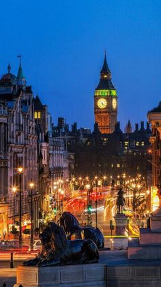 the big ben clock tower towering over the city of london at night with lights on