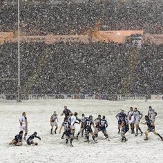 a group of people playing soccer in the snow