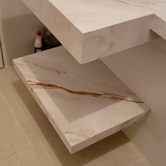 a white marble counter top in a bathroom