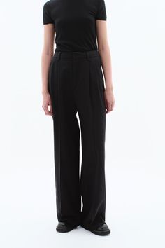 Discover enduring style with the FILIPPA K Darcey Wool Trousers — a permanent staple in your wardrobe. Tailored from a non-stretch suiting wool blend, these black trousers feature a high fitted waist, voluminous pleats, and a generously wide leg with an extra-long length. Size up for a looser waist fit. Complete the look by pairing them with the Davina Blazer for a sophisticated full suit ensemble. #WardrobeEssential #TimelessStyle #SuitingWool #OfficeOutfit Black Wool Wide Leg Pants With Pressed Crease, Black Wool Wide Leg Office Pants, Chic Black Wool Wide Leg Pants, Black Wool High-waisted Wide Leg Pants, Formal Black Wool Wide Leg Pants, Black High-waisted Wool Wide Leg Pants, Black High-waisted Wide Leg Pants For Tailoring, Formal High Waist Pleated Wide Leg Pants, Structured Black Bottoms For Workwear