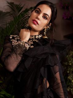 This pre-stitched ruffle saree is suited for any occasion. The saree is made of satin-silk with organza ruffles.  It is paired with a full sleeves blouse embellished with zardosi, pearls and cut-dana on the hem of the sleeves with the rose motifs on the blouse. Formal Bollywood Organza Pre-draped Saree, Tissue Silk Long Sleeve Sharara For Party, Organza Pre-draped Saree For Diwali Evening, Long Sleeve Tissue Silk Sharara For Party, Silk Sharara For Diwali Evening, Elegant Evening Sharara In Tissue Silk, Silk Sharara For Evening And Diwali, Elegant Evening Tissue Silk Sharara, Formal Organza Pre-draped Saree For Diwali