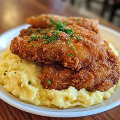 fried chicken and mashed potatoes on a white plate