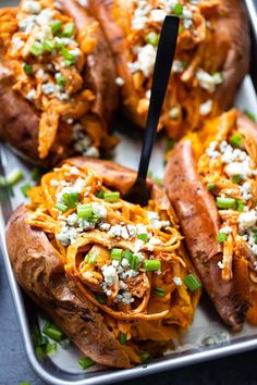 baked sweet potatoes topped with shredded cheese and green onions