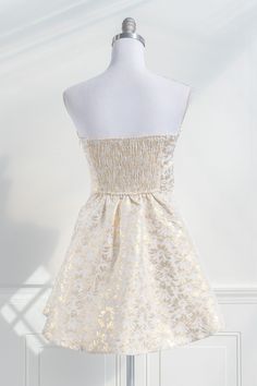 A chic and unique dress, the Heart of Gold mini features removable shoulder straps, a bustier-style bodice, smocked elastic back, and enchanting gold floral jacquard. Perfect for bridal showers, cocktail soirées, or graduation parties. Please Note- This item is final sale only. . Details: S: Bust: 32"-36", Waist: 26"-29" M: Bust 34"-38", Waist: 28"-31" L: Bust 36"-40", Waist: 30"-33" Length Bustier to Hem: 27" Length Waist to Hem: 18" Lined Material: 54% Polyester, 46% Cotton Lining: 100% Rayon Gold Mini Dress, Mini Gold Dress, French Dress, Graduation Parties, Unique Dress, Floral Jacquard, Romantic Dress, French Girl, Gold Floral