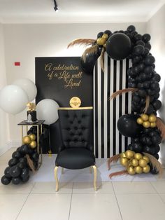 black and gold balloons are on display in a room