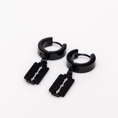 pair black plated alloy earrings with small razor blades attached. made from hypoallergenic alloy measuring in length 1 inch Add a Gothic edge to your style with these unique earrings. Made from a hypoallergenic alloy, these earrings feature small razor blades attached for a daring and edgy look. Measuring in at 1 inch, they are the perfect size for everyday wear. Edgy Black Stainless Steel Earrings, Black Nickel-free Surgical Steel Earrings, Alternative Earrings, Alchemy Gothic, Alloy Earrings, Black Plates, Edgy Look, Earrings Collection, Unique Earrings