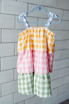 How darling is this Tiered Plaid Toddler Dress? The tiered ruffle flounce dress features bow spaghetti straps. The dress features color-block gingham patterns. The top features blue, followed by yellow, pink and green. This is the perfect springtime dress for playdates, school and more! Match little sister in our Mixed Check Pinafore Baby Set! Dress Features:Fabric: 100% CottonFit: True to SizeWashing Instructions: Turn Inside Out and Machine Wash Cold with Like Colors. Do Not Bleach. Tumble Dry Flounce Dress, Flounced Dress, Baby Set, Toddler Dress, Little Sisters, Baby Sets, Spring Time, Set Dress, Pink And Green