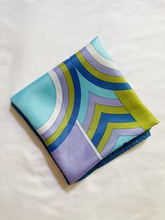 Vintage blue, purple, green geometric print square scarf, very much giving Pucci. 100% acetate. Measures: approx. 26.75" x 26" Trendy Blue Square Silk Scarf, Bethany Beach, Square Scarf, Purple Green, Scarf Print, Geometric Print, Blue Purple, Scarf Wrap, Scarf Accessory