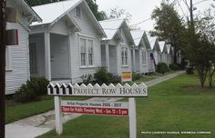 a row of houses with a for sale sign in front