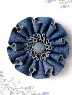 an image of a flower made out of jean fabric on a white background with blue flowers