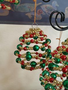 two christmas tree ornaments hanging from hooks