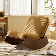 a rocking chair with a book on the floor