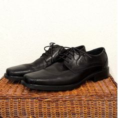 Experience refined style and exceptional craftsmanship with these ECCO New Jersey Lace Oxfords. Designed with a sleek black leather upper material and a durable, sturdy sole, these oxfords bring sophistication to any outfit. The classic box-toe design adds a touch of timeless elegance, making them perfect for both professional and formal settings. With a comfortable fit in men's size 12, these shoes are an essential addition to any well-rounded wardrobe. Elevate your look with the quality and style of ECCO! Rounded Wardrobe, Lace Oxfords, Refined Style, Mens Oxfords, Toe Designs, New Jersey, Black Lace, Timeless Elegance, Shoes Mens