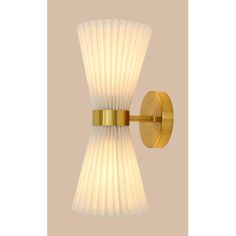 a wall light with a white glass shade on the top and gold trimmings