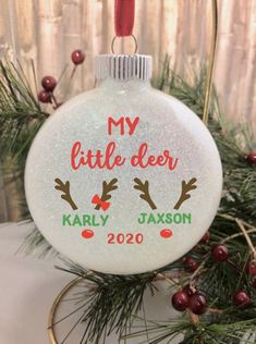 a personalized christmas ornament hanging from a tree