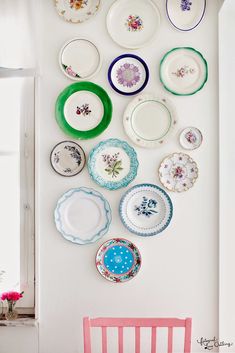 a white wall with plates hanging on it