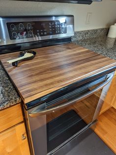 an oven with a cutting board on top of it