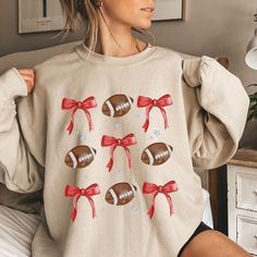 🏈 Coquette Chic Football Sweatshirt for the Ultimate Fan! 🏈 ❤️💙Our design blends the bold team colors of red and blue, capturing the essence of team spirit. With a playful touch of coquette aesthetic, this sweatshirt adds a dash of feminine flair to the classic football fan look. It's the perfect balance of sporty and chic, making it a versatile piece for sports moms, football enthusiasts, and supportive girlfriends alike! 🏉Whether you're tailgating at the stadium or watching from home, our Red Team Sweatshirt For Fall, Red Team Spirit Tops For Fall, Red Sweatshirt With Team Name For Fall, Red Team Name Sweatshirt For Fall, Red Team Spirit Tops For Winter, Cute Football Sweatshirts, Red Team Spirit Sweatshirt For Fall, White Winter Sports Fan Tops, Red Team Name Sweatshirt For Sports Season