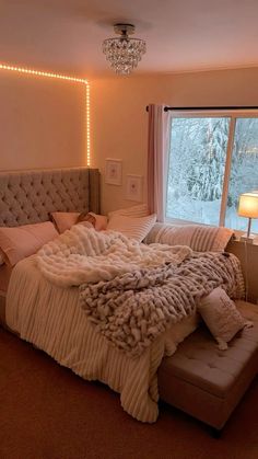 a bedroom with a large bed covered in blankets