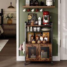 a coffee bar in the corner of a room with green walls and wood flooring