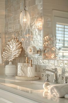 a bathroom sink with a mirror above it and lights hanging from the wall behind it