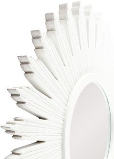 a white mirror that is shaped like a sunflower with spikes on the rim and sides