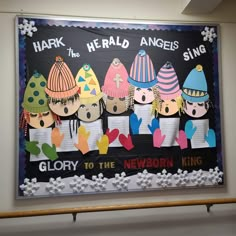 a bulletin board with children's hats and words on it that read, harry the herald angels sing glory to the newborn king