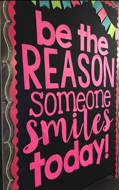 a sign that says be the reason someone smiles today on blackboard with pink lettering