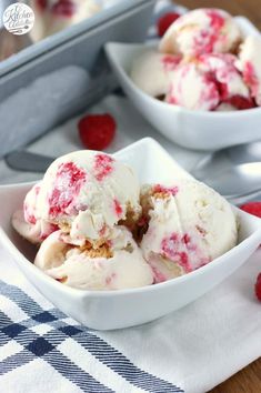 two white bowls filled with ice cream and raspberries