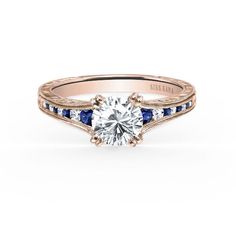 Kirk Kara Rose Gold "Stella" Blue Sapphire Channel Set Diamond Engagement Ring Sapphire Accent Engagement Ring, Channel Set Diamond Engagement Ring, Jewelry Appraisal, Diamond Solitaire Engagement Ring, Sapphire Gemstone, Hand Engraving, Diamond Solitaire, Solitaire Engagement Ring, Timeless Beauty