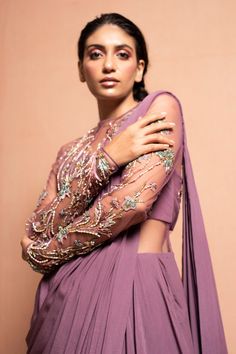 Mauve draped saree gown with floral hand embellished with 3D Silk yarn, crystals, pearls, glass beads and kasab thread work.
Component: 1
Embellished
Neckline: Round
Sleeve Length: Full
Fabric: Crepe
Color: Purple

Sheer back
Closure: Back zip - Aza Fashions Mauve Saree, Draped Saree Gown, Embellished Saree, Saree Gowns, Blouse Yoke, Draped Saree, Gown For Women, Saree Gown, Drape Saree