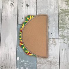 a brown felt with a taco on it sitting on top of a wooden floor