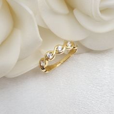 Stunning 14k gold Cubiz zirconia infinity band ring. A modern unique style that will add the final touch to all your outfits. Perfect everyday band. Comfortable & sturdy. 14k gold will not tarnish or rust. Shiny, elegant and everlasting. Will make the perfect gift for her. Materials: 14k gold Weight: 2.2 grams Band widht (top): 4.3mm Band widht (bottom): 2mm Stone count: 6  Total weight: 0.18 Ct 14k stamped  Brand new Fast shipping Contact me if you need a special size! 💓 Briza Collections is a Gold Diamond Ring For Anniversary With Modern Twist, Modern Twist Gold Diamond Ring For Anniversary, Gold Infinity Ring With Prong Setting, Gold Infinity Eternity Band For Promise, Elegant Gold Infinity Diamond Ring, Half Eternity Infinity Ring For Anniversary, Elegant Infinity Yellow Gold Diamond Ring, Elegant Yellow Gold Diamond Ring With Infinity Shape, Elegant Yellow Gold Diamond Infinity Ring