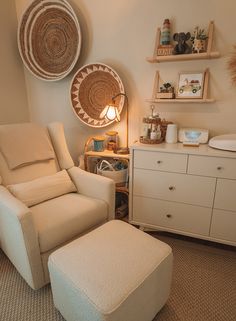 a white chair and ottoman in a child's room with baskets on the wall