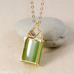 "Here is a AAA grade Siberian emerald green nephrite jade set in solid 18KT yellow gold and accented with round full cut white diamonds. This pendant is designed with a chevron accent. It is modern with simple clean lines. The jade is natural and untreated. This nephrite jade has a beautiful glowing apple green color. Stone & Dimensions: Natural Untreated gem grade AAA Siberian Emerald Green Nephrite Jade: approximately 11.2 carats 16mm long x 12mm wide x 5mm thick, Overall size of pendant: Art Deco Gold Jewelry With Rectangular Stone, Rectangular Green Gemstone Jewelry, Green Rectangular Pendant Jewelry For Formal Occasions, Green Rectangular Pendant For Formal Occasions, Elegant Rectangular Jade Necklace, Green Rectangular Necklace For Formal Occasions, Formal Rectangular Jade Jewelry, Formal Green Rectangular Necklace, Rectangular Jade Gemstone Necklaces