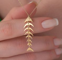 Our fish necklace is 14k solid gold. It has a unique style that you will love it! Our fishbone pendant's bones are not stable. These bones are dangling on the margin of the other bone. If you think of this gold unique necklace as a gift, it makes happy your loved ones on their birthdays, mother's day, graduation, anniversaries, valentine's day, or women's day. 🎁 We can add a gift note for your loved ones. It arrives in a special jewelry gift box. ✨ We respond to your questions happily. Your que Gold Fish Jewelry, Fishbone Necklace, Gold Fish Necklace, Fish Bone Necklace, Ethereal Jewelry, Gold Jewels Design, Preppy Jewelry, Fish Jewelry, Fish Necklace