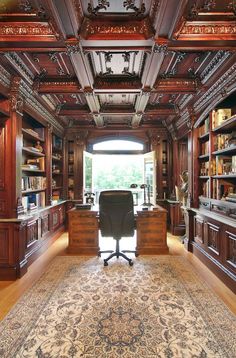 an elegant home office with wood paneled walls and ceilinging, along with a large rug on the floor