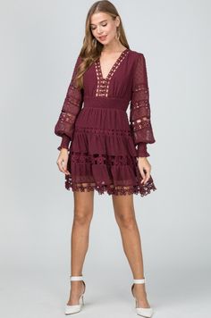 Nothing says romance like the Felicity Burgundy Long Sleeve Flare Mini Dress! Swiss dot fabric forms this lovely burgundy dress with altering crochet floral lace details. Features a plunging V-neckline, fitted button-down bodice, long blouson sleeves with smocked cuffs. Empire waist falls into an attached tiered flared mini skirt. Back hidden zipper/clasp closure. Partially lined. Long Sleeve Dresses With Lace Trim For Brunch, Chic Party Dress With Crochet Trim, Chic V-neck Mini Dress With Crochet Trim, V-neck Dress With Lace Cuffs, Long Sleeve Lace Dress With Patchwork For Brunch, Elegant Mini Dress With Crochet Trim, Long Sleeve Lace Mini Dress With Lace Trim, V-neck Lace Dress With Lace Cuffs, Spring V-neck Dress With Lace Cuffs