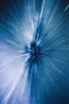 an abstract blue background with stars in the center and light streaks coming out from behind it