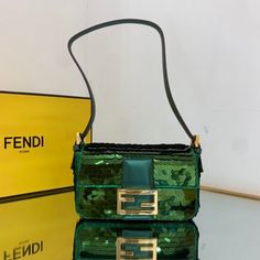 SHOP MORE LUXURY PRODUCTS HERE Description Fendi Mini Baguette 1997 Green Sequinned Bag For Woman 19.5cm/7.5in 8BS049AISLF1H38 Size: 19.5 x 5 x 11 cm / 7.5 x 2 x 4.5 inch Mini 1997 Baguette bag with all-over green metallic sequin embroidery, embellished with an FF clasp.This style is a re-release of the first Fendi Baguette, created in 1997, from which it takes its name and the iconic design to wear under the arm.Featuring a front flap, tone on tone metallic leather details and a magnetic clasp. Luxury Baguette Bag For Shopping, Green Rectangular Baguette Bag With Gold-tone Hardware, Luxury Green Baguette Bag For Shopping, Rectangular Baguette Bag With Gold-tone Hardware For Party, Luxury Baguette Shoulder Bag For Party, Designer Rectangular Baguette Bag For Party, Luxury Baguette Bag For Party, Party Baguette Bag With Gold-tone Hardware, Luxury Green Baguette Shoulder Bag