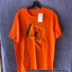 Nwt.. For The Ultimate Jordan Fan.. Orange In Color!! Comes From A Smoke Free Home With No Rips, Holes Or Stains.. Nike Orange Crew Neck T-shirt, Orange Crew Neck Shirt For Streetwear, Orange Crew Neck Shirt With Graphic Print, Nike Casual Orange Tops, Orange Graphic Tee For Streetwear, Casual Nike Orange Tops, Casual Orange Nike Tops, Orange Letter Print Tops For Streetwear, Orange Cotton Tops With Logo Print