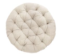 a white round cushion on a white background