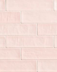 a white brick wall that is very light pink