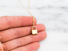 "Dainty lock necklace! The pendant is made of gold vermeil, which is heavy gold plating over sterling silver. Pair it with your favorite outfit! Layer with other necklaces, by or wear itself for a pop! . . . . . . . . . . . . . . . . . . . . . . . . . . . . . . . . . . . . . . . . . . NECKLACE + Length: 16\" + 2\" extender + Vermeil (18k gold plating over sterling silver) -or- sterling silver lock pendant: 8mm x 11mm + 14k gold filled -or- sterling silver chain, spring clasp, & findings LAYE Yellow Gold Chain Necklace With Gold Clasp As Gift, Gold Locket Necklace With Lobster Clasp As Gift, Gold Locket Chain Necklace As Gift, Gold Locket Chain Necklace For Gift, Everyday Gold Lock Jewelry, Everyday Gold Jewelry With Lock Detail, Gold Chain Necklace With Lock For Gift, Gold Lock Necklace As Gift, Yellow Gold Necklace With Lock As Gift