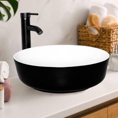 a black and white bowl sink sitting on top of a counter