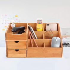 a wooden desk organizer filled with office supplies