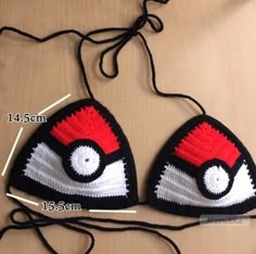 two crocheted pokemon hats are shown on a table with measurements for each one